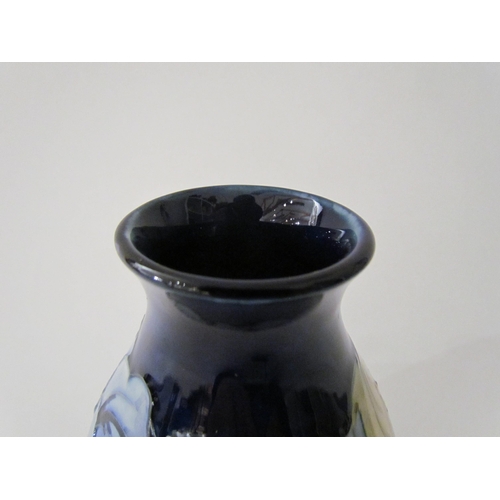 7558 - A Moorcroft Hibiscus pattern vase in pale blue with dark blue ground, 14cm tall