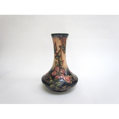 7569 - A Moorcroft Sweetbriar pattern vase, 21cm tall