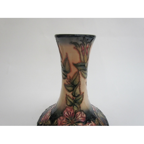 7569 - A Moorcroft Sweetbriar pattern vase, 21cm tall