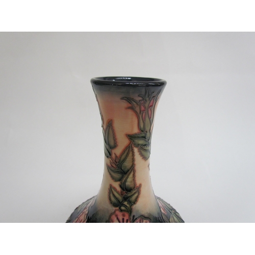 7569 - A Moorcroft Sweetbriar pattern vase, 21cm tall