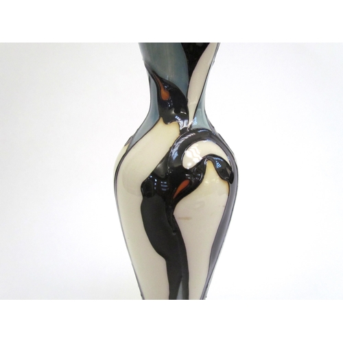 7571 - A Moorcroft Pole to Pole pattern vase with Penguin design, 21cm tall