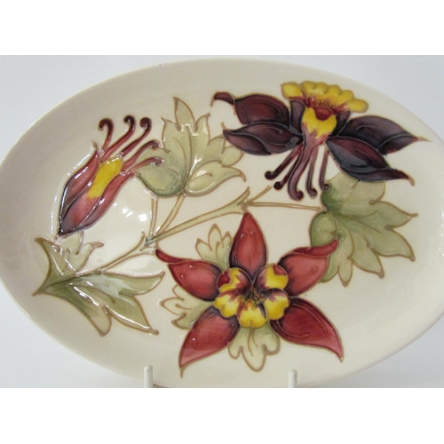 7574 - A Moorcroft Aquilegia pattern oval plate, 23cm x 15.5cm