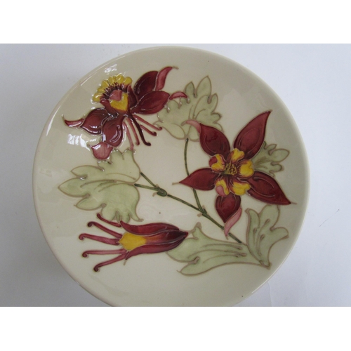 7575 - A Moorcroft Aquilegia pattern shallow bowl on cream ground, 18.5cm diameter