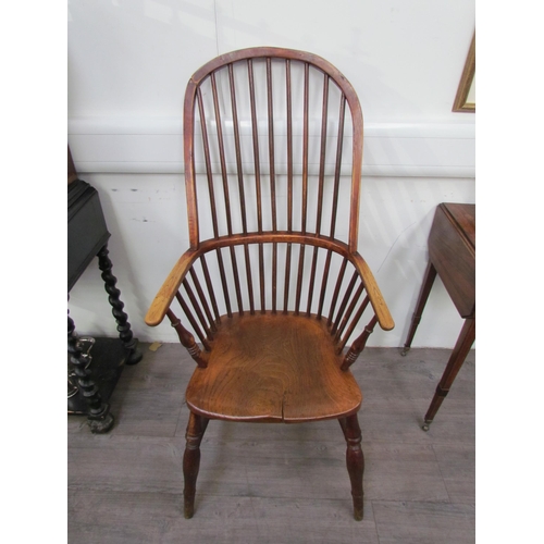 7591 - A pair of circa 1800 his and hers Windsor chairs, the hoop and stick-back over a solid elm seat, on ... 