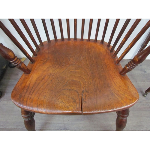 7591 - A pair of circa 1800 his and hers Windsor chairs, the hoop and stick-back over a solid elm seat, on ... 