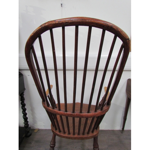 7591 - A pair of circa 1800 his and hers Windsor chairs, the hoop and stick-back over a solid elm seat, on ... 