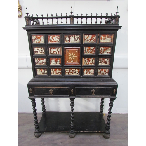 7594 - An 18th Century European cabinet on stand, the spindle rail cornice over an eight drawer and single ... 