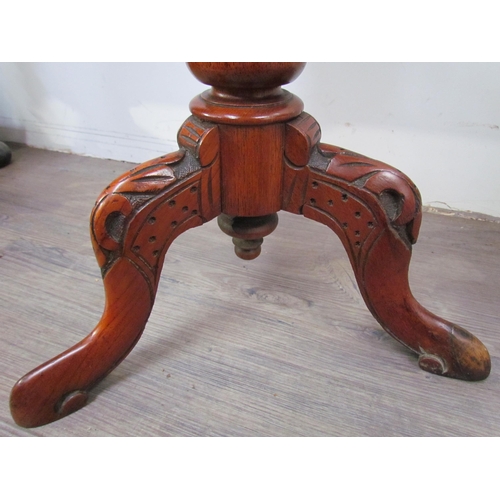 7606 - A reproduction burr walnut sewing table, the octagonal top over a faceted column to a carved tripod ... 