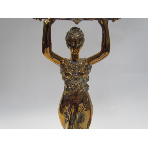 7644 - A pair of brass candlesticks as robe clad females, upon grey marble plinth bases, 30cm high