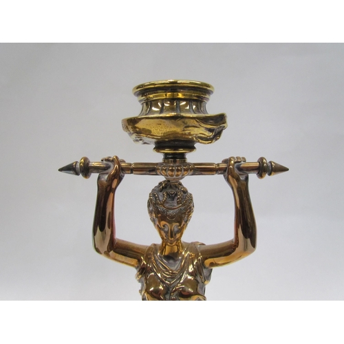 7644 - A pair of brass candlesticks as robe clad females, upon grey marble plinth bases, 30cm high