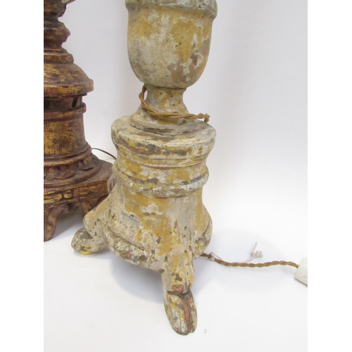 7019 - Three 19th Century carved wood lamp bases in a rustic condition, 94cm, 76cm and 73cm tall