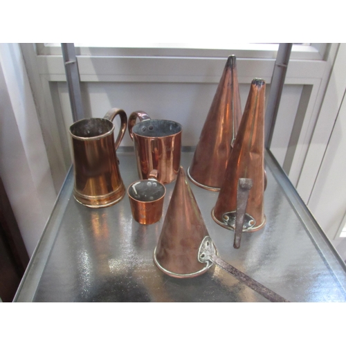 7077 - A Georgian copper tankard with wooden base, three copper funnel grain measures and two further measu... 