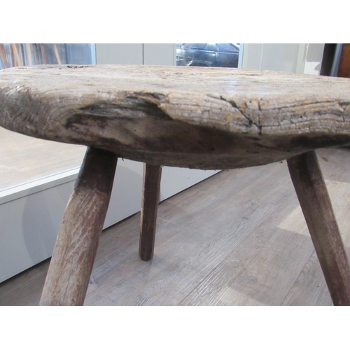 7082 - A primitive 18th Century Elm cricket table with thick circular top on three rustic legs. 53cm tall x... 