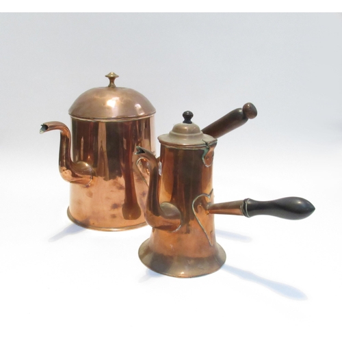 7084 - A Victorian large copper coffee pot with treen handle and another with ebony handle of smaller form.... 