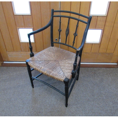 7094 - A Regency ebonised carver chair with rush seat, 87cm x 54cm x 43cm