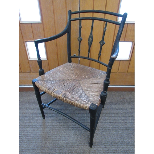 7094 - A Regency ebonised carver chair with rush seat, 87cm x 54cm x 43cm