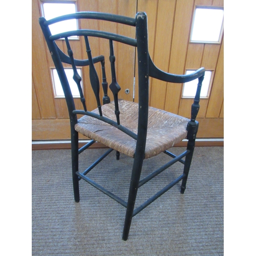 7094 - A Regency ebonised carver chair with rush seat, 87cm x 54cm x 43cm