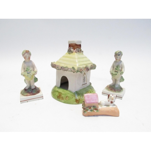 7100 - A Victorian Staffordshire cottage pastille burner, two early 19th Century Staffordshire figures of c... 