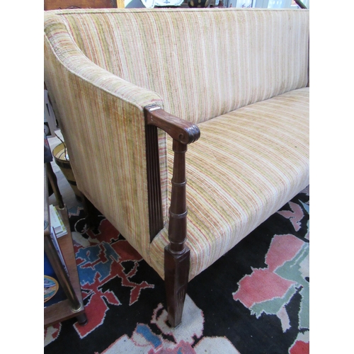 7103 - A late 19th Century square back sofa with turned arms to reeded tapering square legs to castors, uph... 