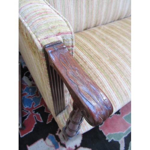 7103 - A late 19th Century square back sofa with turned arms to reeded tapering square legs to castors, uph... 