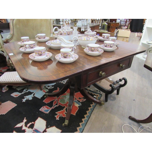 7112 - A Regency mahogany drop flap library centre table with one true drawer, ring turned column to quatre... 