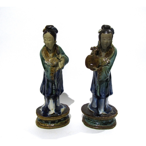 7159 - A pair of late 19th Century / early 20th Century glazed Shiwan pottery figures both with areas of da... 