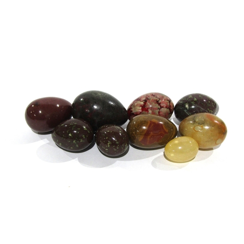 7170 - Seven polished stone eggs and another, all of varying sizes, largest 7cm, smallest 4cm