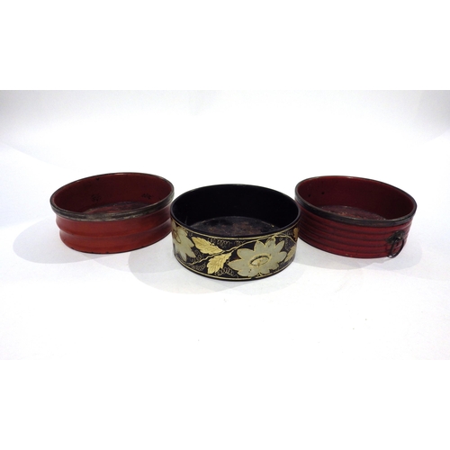 7193 - Three Regency papier-mache wine bottle coasters circa 1820, two red one black decorated with flowers... 