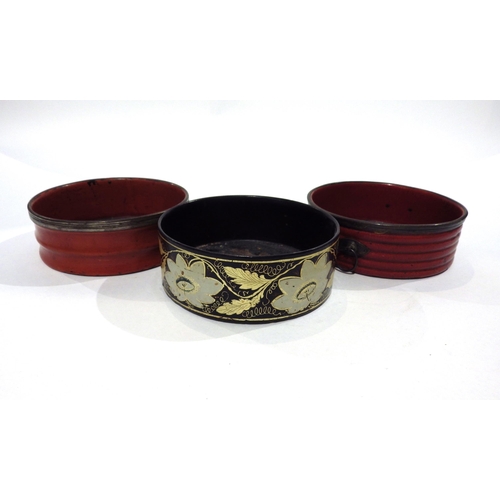 7193 - Three Regency papier-mache wine bottle coasters circa 1820, two red one black decorated with flowers... 