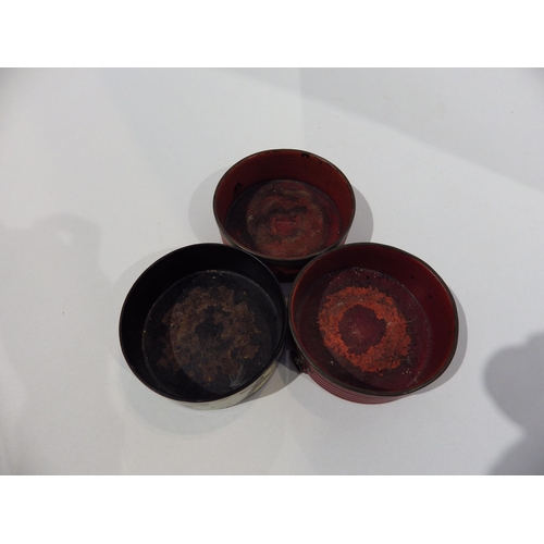 7193 - Three Regency papier-mache wine bottle coasters circa 1820, two red one black decorated with flowers... 