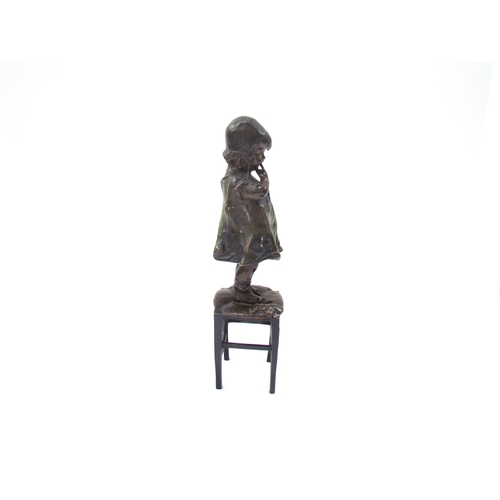 7617 - JUAN CLARA AYATS (1875-1958): A bronze sculpture of young girl standing on a rush seated stool, hold... 