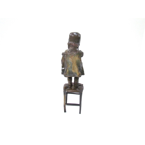 7617 - JUAN CLARA AYATS (1875-1958): A bronze sculpture of young girl standing on a rush seated stool, hold... 