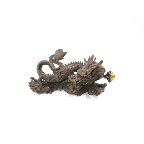 7626 - A Chinese bronze five clawed dragon. 23cm length