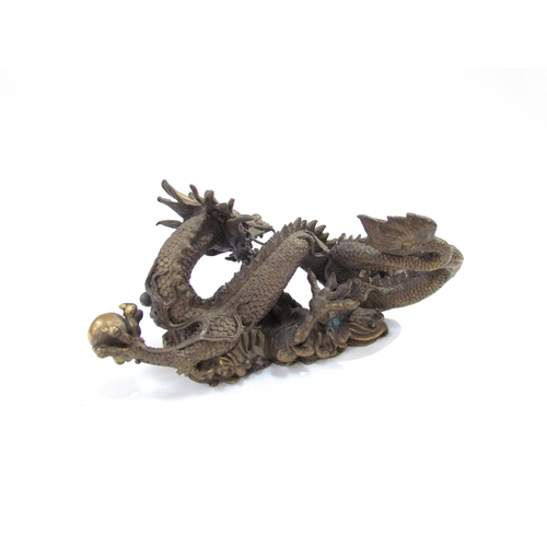 7626 - A Chinese bronze five clawed dragon. 23cm length