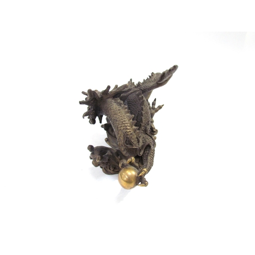 7626 - A Chinese bronze five clawed dragon. 23cm length