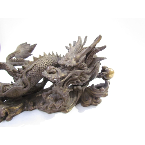 7626 - A Chinese bronze five clawed dragon. 23cm length