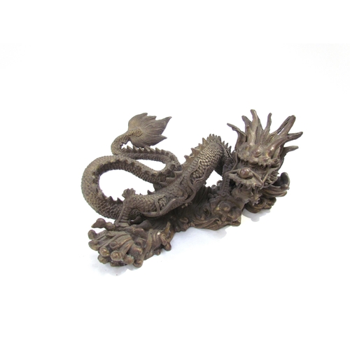 7626 - A Chinese bronze five clawed dragon. 23cm length