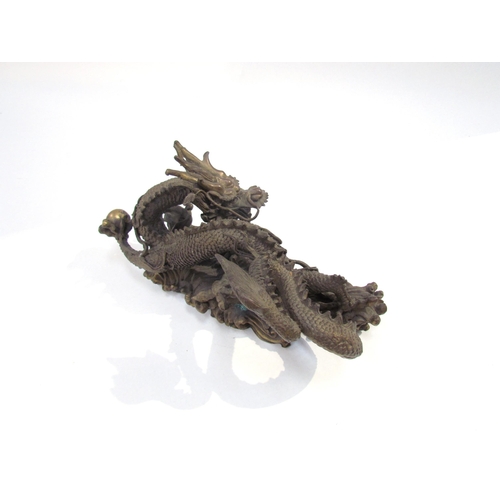 7626 - A Chinese bronze five clawed dragon. 23cm length