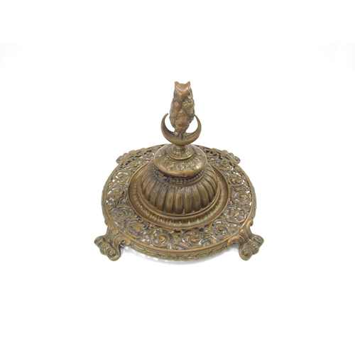 7633 - A Victorian pierced brass desk inkwell with owl on crescent moon lid, scrolled foliate detail, 21.5c... 