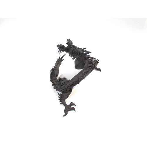 7636 - A bronze figure of an Oriental dragon, 13.5cm tall