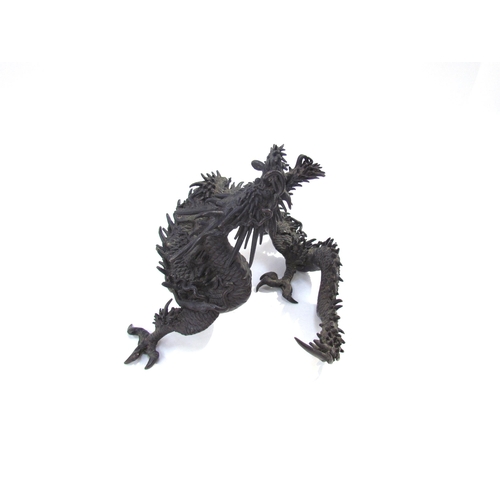 7636 - A bronze figure of an Oriental dragon, 13.5cm tall