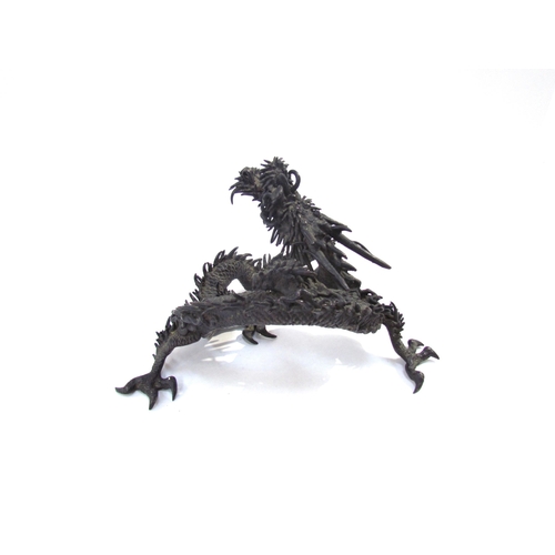 7636 - A bronze figure of an Oriental dragon, 13.5cm tall