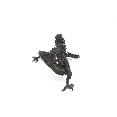 7636 - A bronze figure of an Oriental dragon, 13.5cm tall