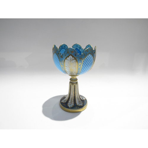 7728 - A fine Bohemian glass goblet, pale blue with foliate and crosshatch panels, enriched with gilt, 23cm... 