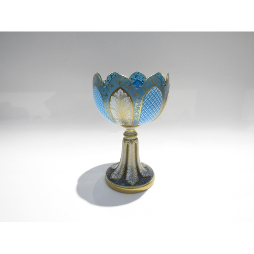 7728 - A fine Bohemian glass goblet, pale blue with foliate and crosshatch panels, enriched with gilt, 23cm... 