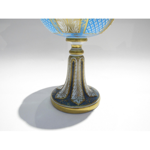 7728 - A fine Bohemian glass goblet, pale blue with foliate and crosshatch panels, enriched with gilt, 23cm... 