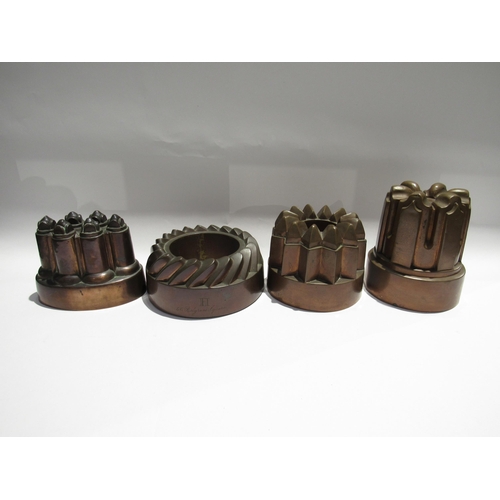 7733 - Four 19th Century copper jelly moulds. Three cast iron form, all varying in size. Three have monogra... 