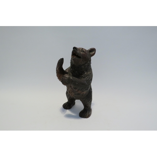 7765 - A Black Forest carved sculpture of a standing bear, 26cm high