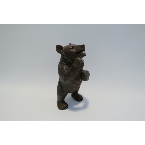 7765 - A Black Forest carved sculpture of a standing bear, 26cm high