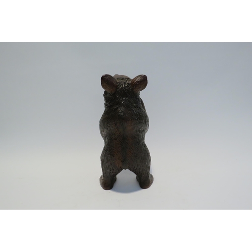 7765 - A Black Forest carved sculpture of a standing bear, 26cm high